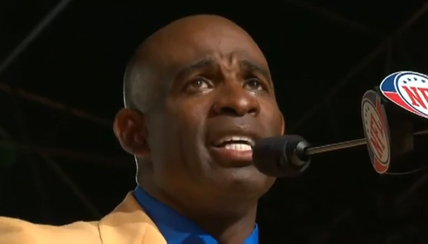 Photo shows Deion Sanders giving his emotional Hall of Fame Sppech. Sanders is also a dynamic motivational speaker and is one of our more popular athlete speakers says Sports Speakers 360.
