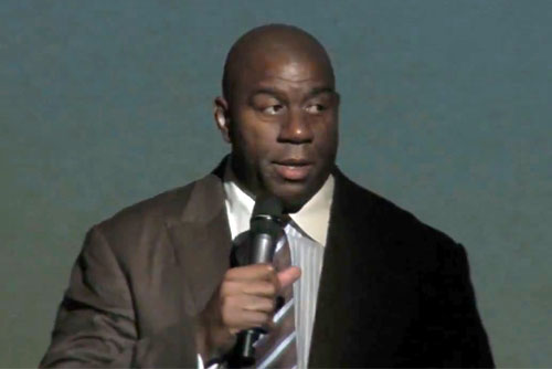 Photo shows magic Johnson delivering the keynote speech  at the National Cowboy and Western Heritage Museum for the Champions of Health Gala supporting Oklahoma Caring Foundation.