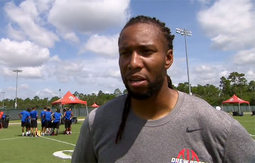 larry-fitzgerald-drew-brees-passing-academy-orlando-fl-jun-2014